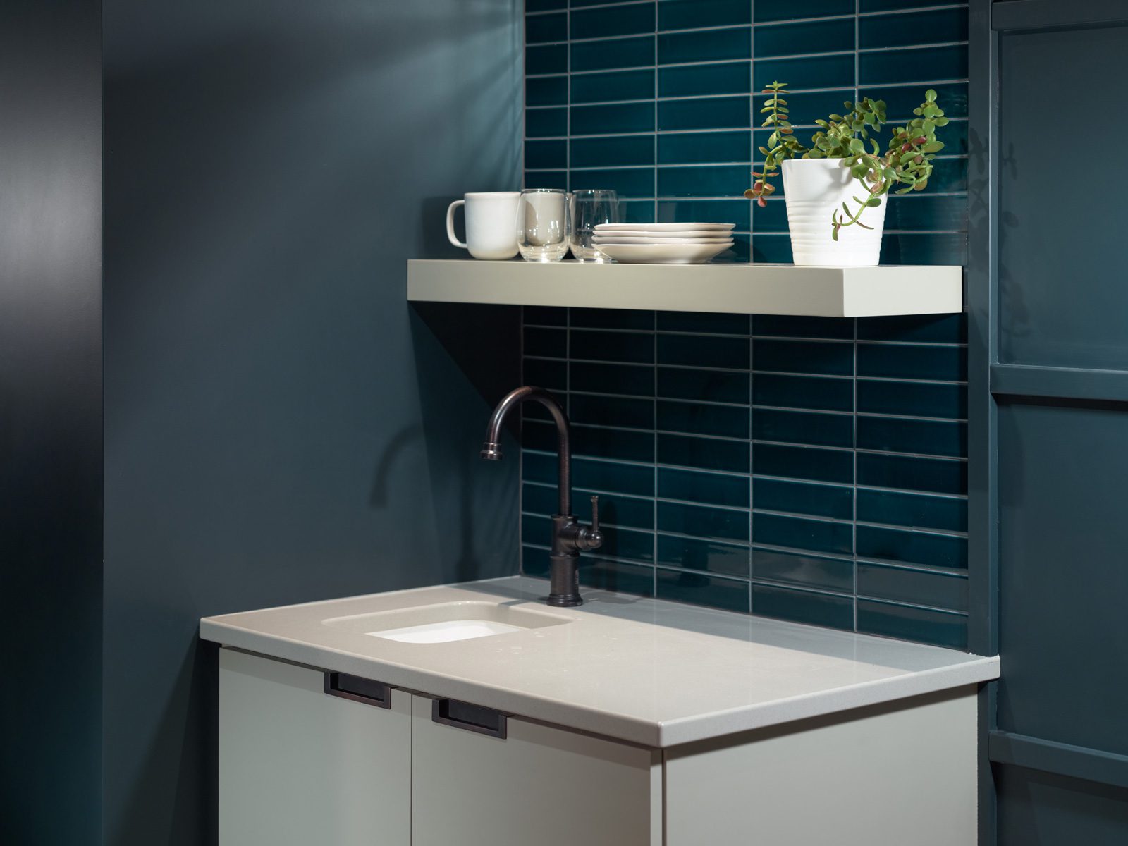 A dark blue tile wall with wet bar in a suite at the Harbor Grand Hotel in New Buffalo, Michigan